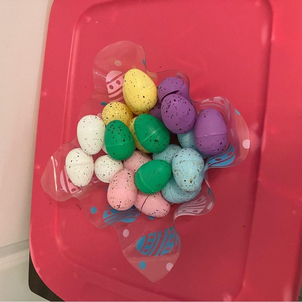 decorative Easter basket featuring a large pink bow assorted pastel-colored eggs